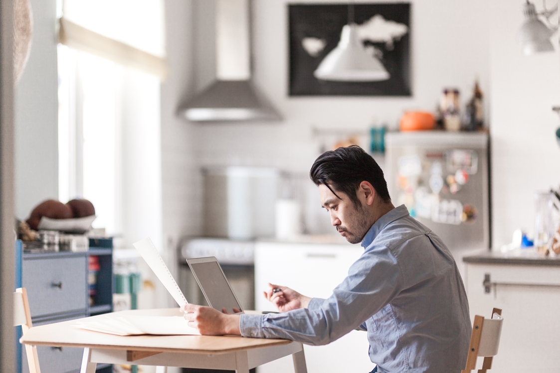 Image of man teleworking at home desk.